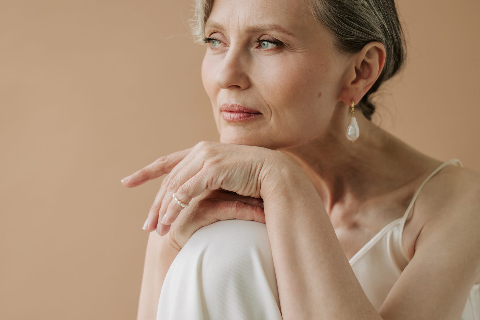 Mature Woman Wearing Pearl Earring and Ring